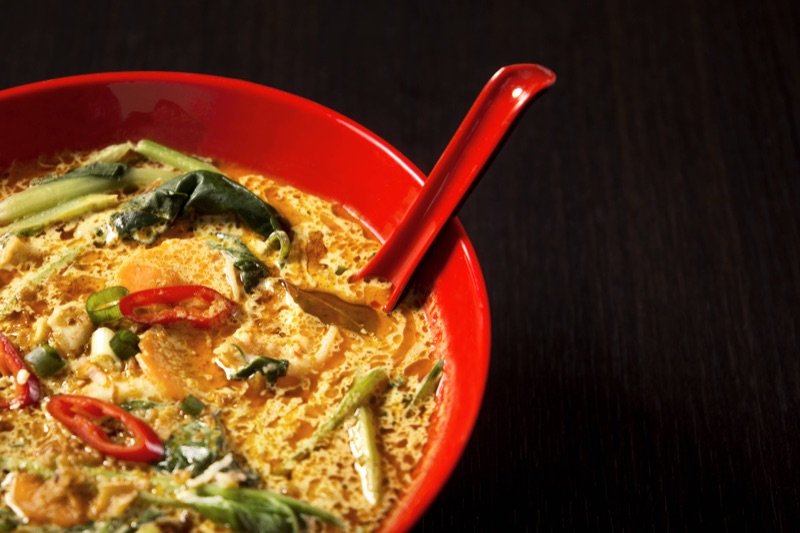 A bowl of laksa — spicy Malaysian noodle soup in coconut gravy